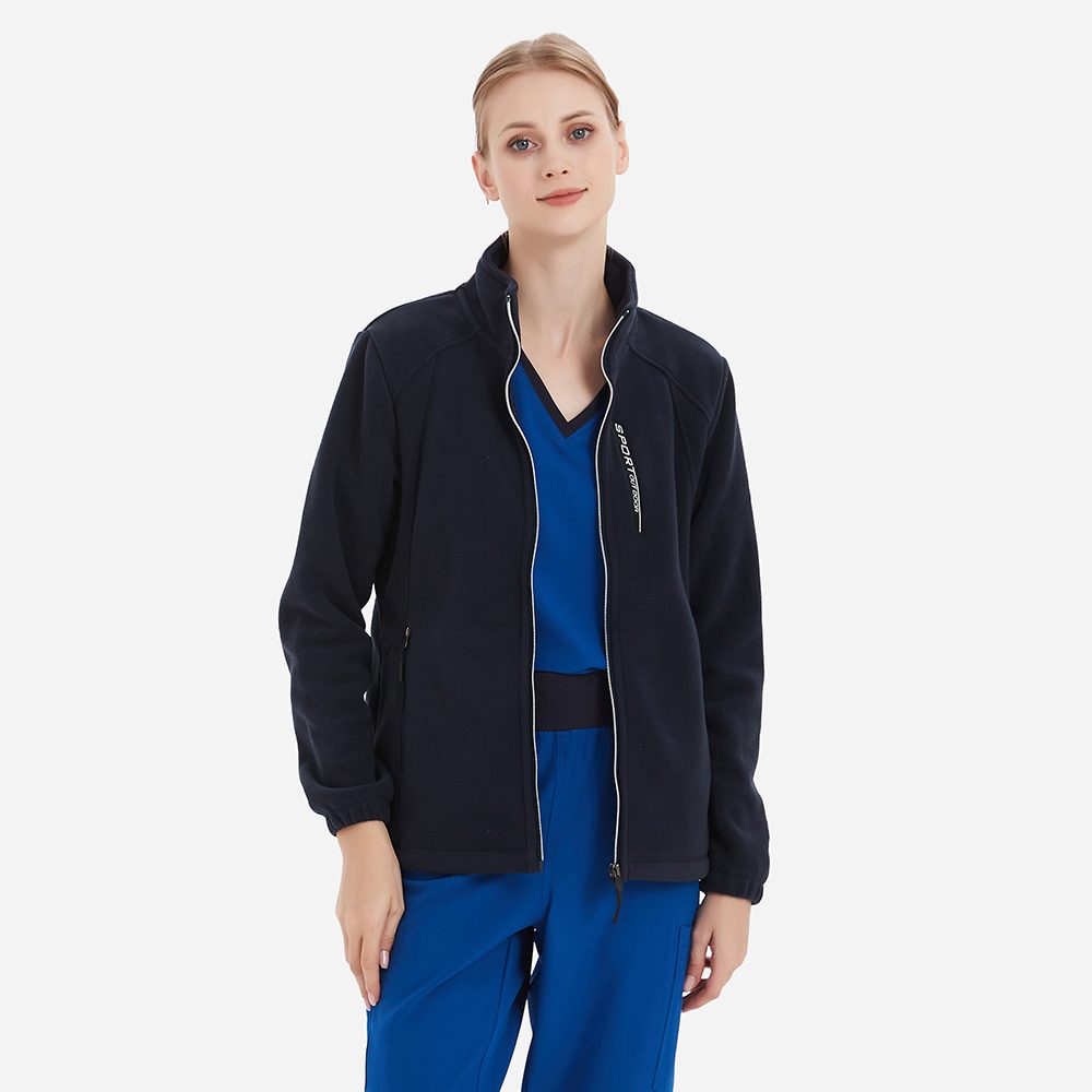Fleece jacket worn open over scrubs